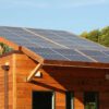 Roof-mounted solar panels on an eco-friendly wooden building